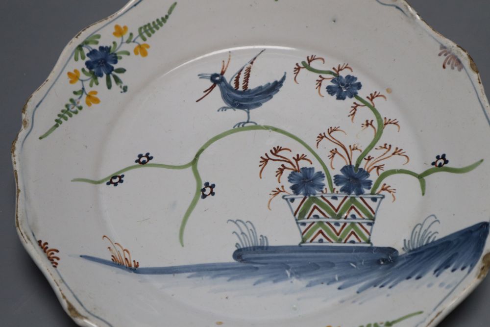 An 18th century faience dish, painted in polychrome enamels, 23cm